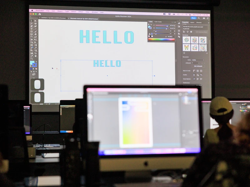 A CalArts student holds u an ipad to a projection during class. 