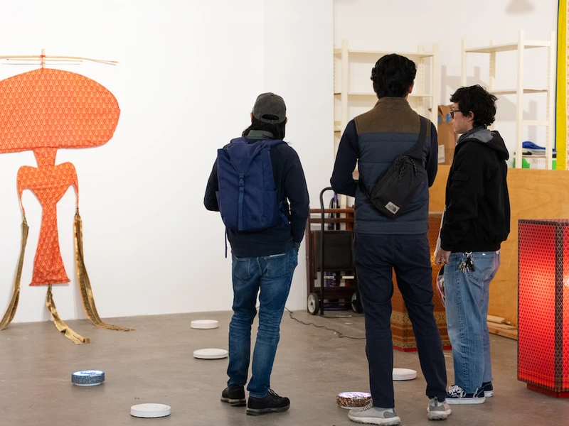 Studio visitors at CalArts explore some work made by art students. 