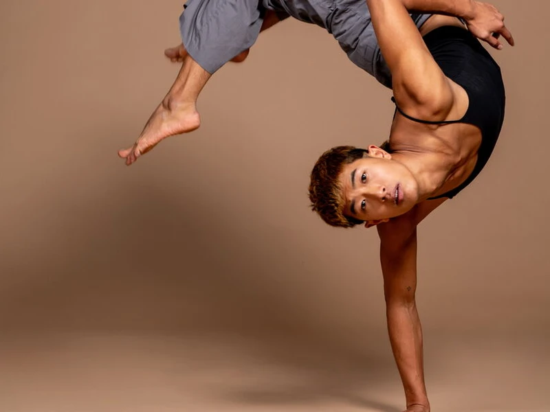 A CalArts Dancer does a handstand 