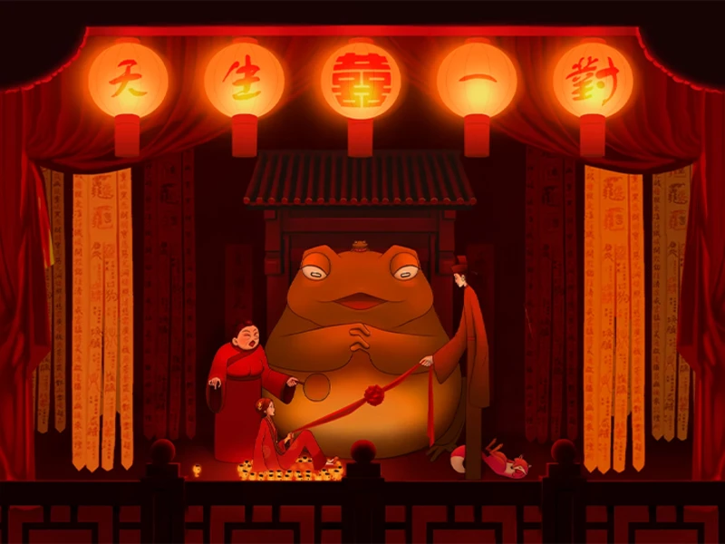 A theatrical stage set with a large humanoid frog statue, flanked by two figures in traditional attire, with red lanterns and drapes.