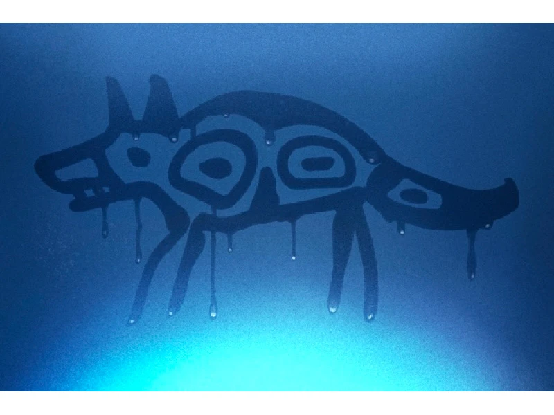 Silhouette of an abstract coyote-like figure with geometric patterns on a blue background.