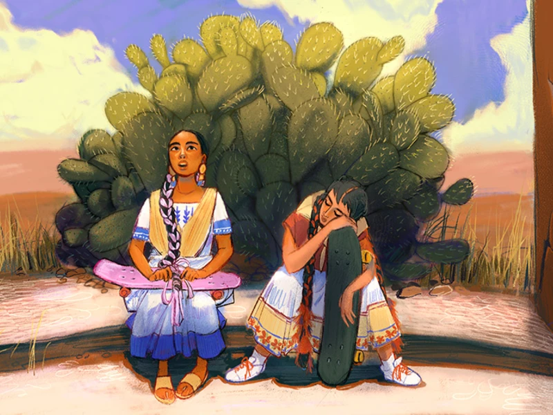 Two young women with skateboards sit in front of a cactus in a desert setting.