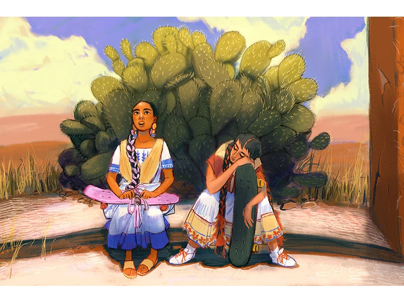 Two young women with skateboards sit in front of a cactus in a desert setting.