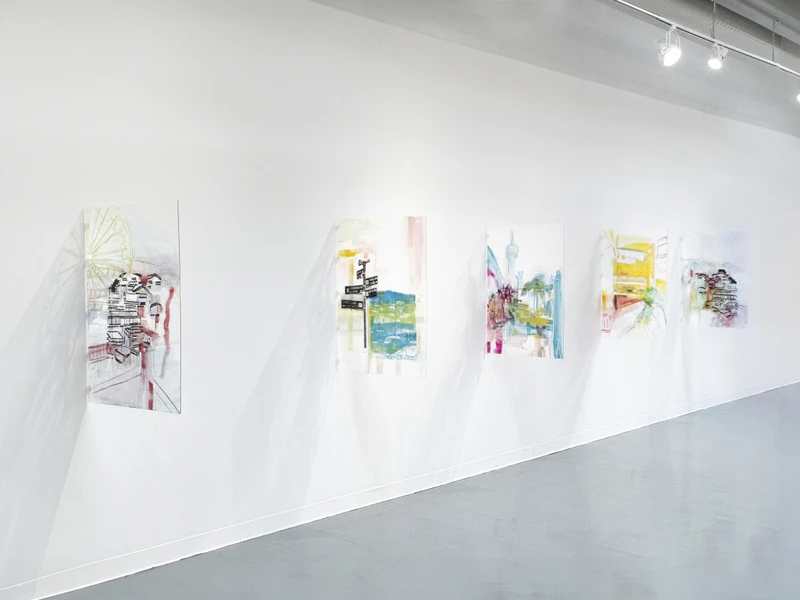 A row of five abstract paintings displayed on a white gallery wall under spotlights.
