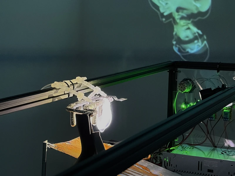 Laboratory setup with equipment and projected image on a wall.