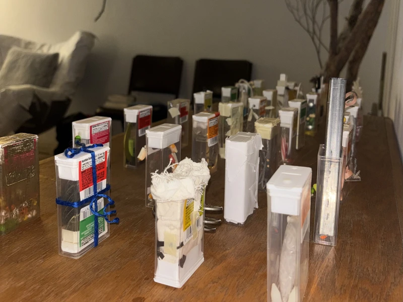 Various clear plastic containers filled with different objects on a wooden table.