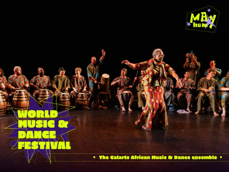 A dancer performs in front of a group of drummers at the World Music & Dance Festival.