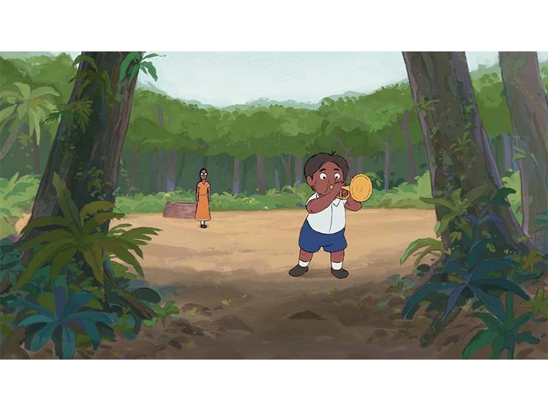 A young boy plays a small drum in a forest, with a woman watching in the distance.